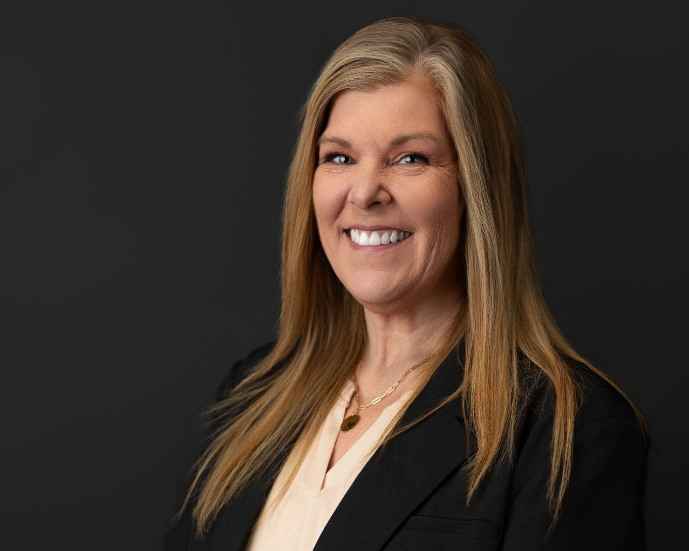 Donna Mullins, founder of Embellish My Heart, a Louisville laser engraving studio, professional headshot in black blazer