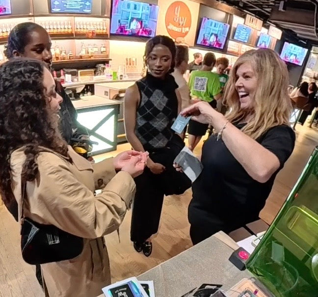 Donna from Embellish My Heart live laser engraving event entertainer handing personalized engraved item to excited guest at corporate event Louisville KY